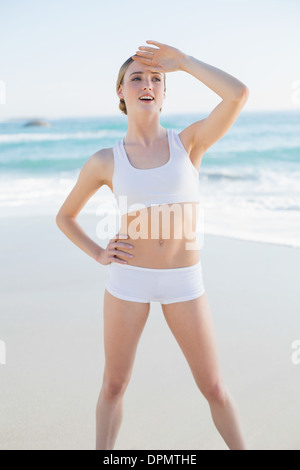 Happy slender woman standing hands on hips looking away Stock Photo