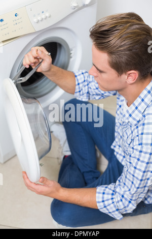 Technician repairing a washing machine Stock Photo