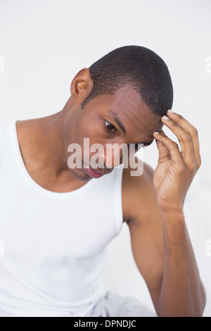 Close up of a young Afro man suffering from headache Stock Photo