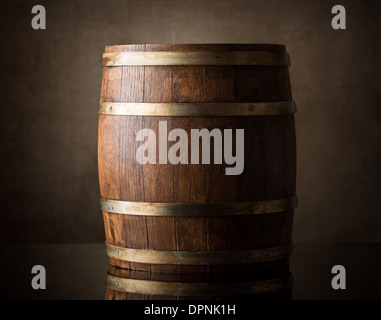 Old wooden barrel on a brown background Stock Photo