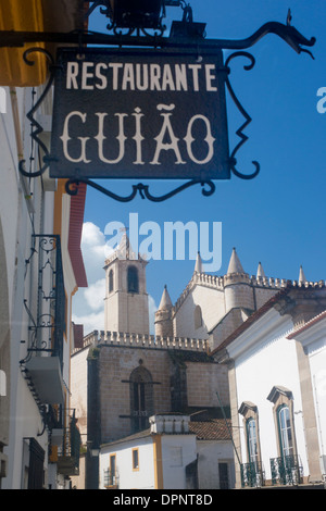 Évora Igreja de Sao Francisco Church of St Francis with restaurant sign in foreground street scene Alentejo Portugal Stock Photo