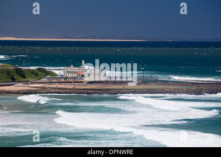 Distant view of Ocean Baths with Pacific Ocean, Stockton dunes and beach in distance Newcastle New South Wales NSW Australia Stock Photo