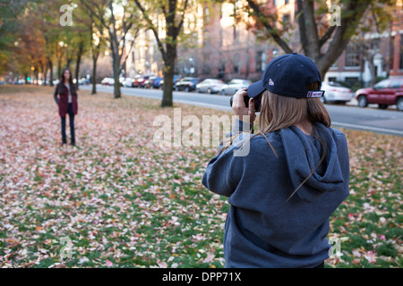 A woman poses for her photographer friend in a park in Boston. Stock Photo