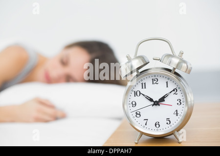 Retro alarm clock standing on bedside table Stock Photo