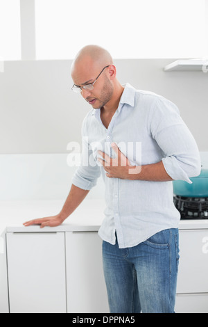Casual man suffering from chest pain at home Stock Photo