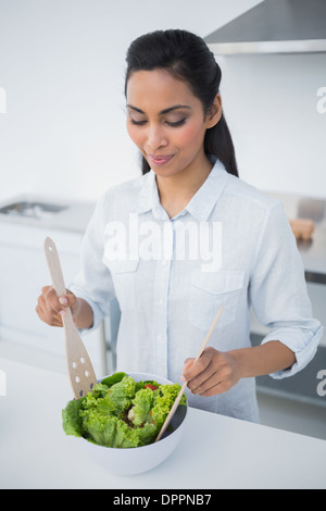 Lovely peaceful woman preparing salad in kitchen Stock Photo