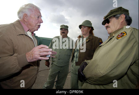 Dec. 17, 2005 - Santa Monica, California, USA - James McInnes, left, who served in the British armored division which invaded Normandy Beach on D-Day, June 6, 1944, gives a living history lesson to Terry Kaplan and Leah and Luther Ritter after groundbreaking ceremonies for DC Monument Park at the Santa Monica Airport, in CA., on Saturday, Dec. 17, 2005, the 70th anniversary of the  Stock Photo