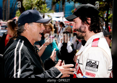 Apr 21, 2009 - Long Beach, California, USA -  Artist WYLAND, who will be a painting a giant earth on the roof of the  Long Beach Arena in the background for Earth Day,  and KEANU REEVES pose for photographers on Qualifying Day for the Toyota Pro/Celebrity Race April 17, 2009. Wyland also painted  the exterior ocean scene that covers the exterior of the arena.  (Credit Image: © Jona Stock Photo