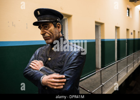 USHUAIA, Argentina - A life-sized model of a prison guard looking down over the cell blocks at the Maritime Museum of Ushuaia. The museum consists of several wings devoted to maritime history, Antarctic exploration, an art gallery, and a policy and penitentiary museum. The complex is housed in an historic prison building and uses the original cells and offices as exhibit spaces. Stock Photo