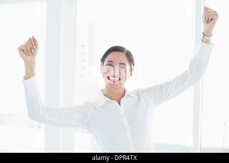Business woman with clenched fists at office Stock Photo