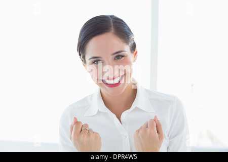 Excited young business woman clenched fists Stock Photo