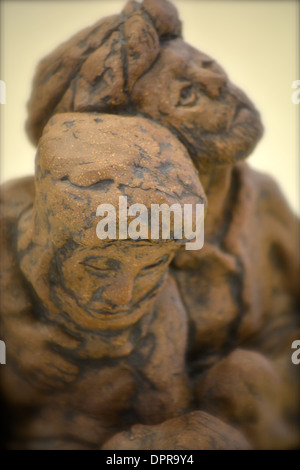 Figurine of two people comforting each other Stock Photo