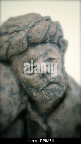 Figurine of two people comforting each other Stock Photo