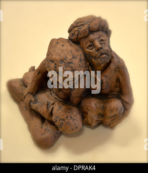 Figurine of two people comforting each other  Stock Photo