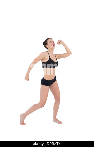Sporty young woman dancing isolated on white background Stock Photo