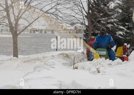 Mar 26, 2009 - Fargo, North Dakota, USA - A volunteer blows snow in the Meadow Creek neighborhood of Fargo. volunteers add another foot of sand bags due to rising flood waters. The cities of Moorhead and Fargo are pushing to finish primary and secondary dikes by the end of Thursday in preparation for Friday's expected record crest of the Red River. (Credit Image: © Dave Arntson/ZUM Stock Photo