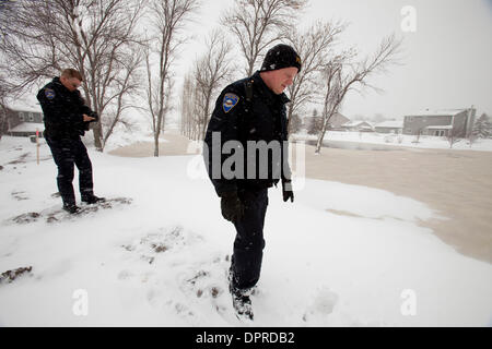 March 31, 2009 - Moorhead, Minnesota, USA - Moorhead police officers JEFF NELSON, right, and BRIAN DAHL examine a dike in Moorhead, Minn. along the Red River on foot during a snowstorm Tuesday, March 31, 2009. Up to 18 inches of new snow are expected to fall in the Fargo, N.D. and Moorhead area by Wednesday. (Credit image: © Dave Arntson/ZUMA Press) Stock Photo