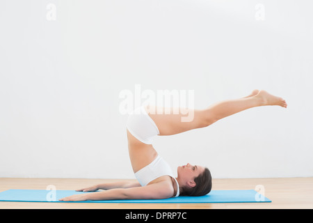 Sporty young woman doing the plough posture Stock Photo