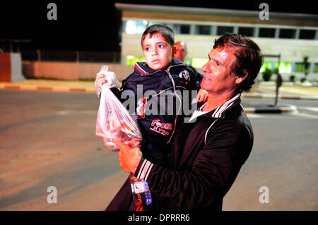 Jan 28, 2009 - Erez, Israel - A Palestinian child who became an orphan from the recent war between Israel and Hamas, crosses through to Israel from Gaza at the Erez border crossing on Wednesday January 28, 2009. Hamas has allowed only one out of forty-eight children to cross through to Israel so far. Kibbutz Movement initiative in cooperation with Haifa, Kibbutz Sasa, Kfar Qassem p