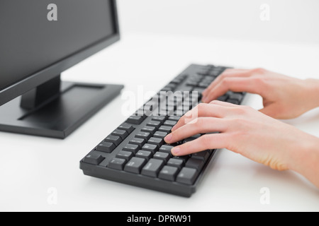 Hands typing on keyboard in an office Stock Photo