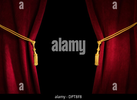 Red velvet curtain with tassel. Close up black isolated curtain Stock Photo