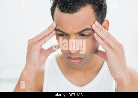 Close-up of a young man suffering from headache Stock Photo