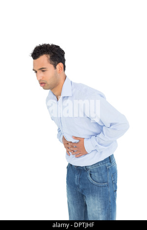 Casual young man with stomach pain Stock Photo