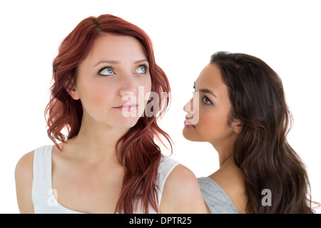 Unhappy young female friends not talking after argument Stock Photo