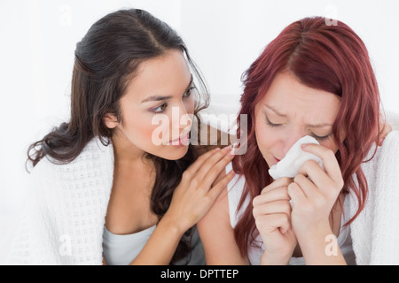Young woman consoling a crying female friend Stock Photo