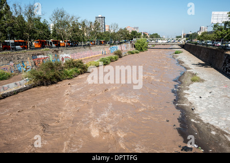 The Mapocho River flows through Santiago de Chile, dividing the city in half. The source of the river is the Andes mountains. Stock Photo