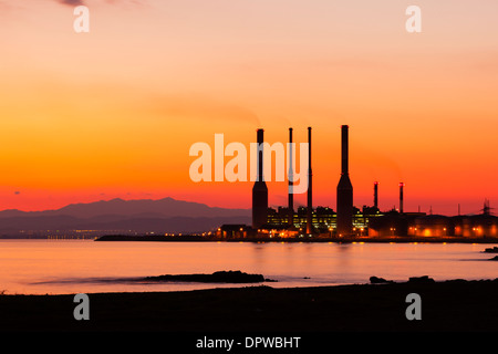 Dhekelia Power Station, Larnaca Cyprus at sunset with mountain range beyond Stock Photo