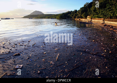 Plastic bottles, bags and other garbage pollute a south coast beach on Bunaken Island, a marine national park of Indonesia Stock Photo
