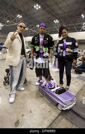 Nov 25, 2008 - Chiba, Japan - Customized classic cars showcasing the American lowrider culture are displayed at the Lowrider Japan Car Show which took place at Makuhari Messe Convention Center in Chiba, Japan. Pictured: Japanese fans pose for a picture at the Lowrider Japan Car Show. (Credit Image: © Christopher Jue/ZUMA Press)