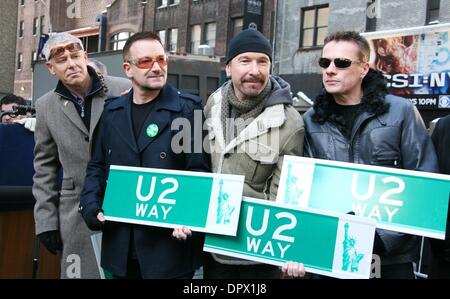 Mar 03, 2009 - New York, New York, USA - ADAM CLAYTON, BONO, THE EDGE, and LARRY MULLEN JR. from the band U2, hold 'U2 Way' Street signs at unveiling of the temporary name change of West 53rd Street and Broadway to 'U2 Way' for one week. (Credit Image: Â© Nancy Kaszerman/ZUMA Press) Stock Photo