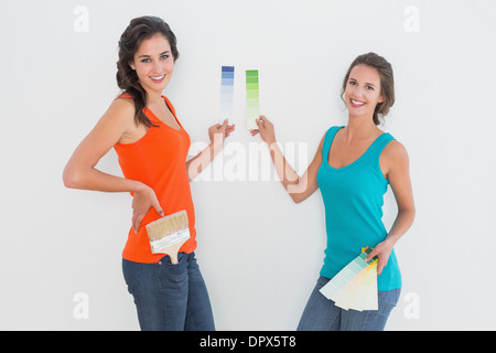 Side view portrait of two female friends choosing color Stock Photo