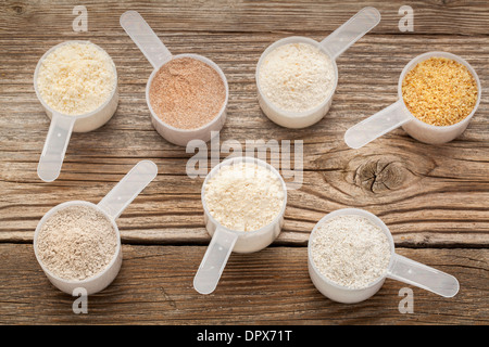 top view of measuring scoops of gluten free flours - almond, coconut, teff, flaxseed meal, whole rice, brown rice, buckwheat Stock Photo