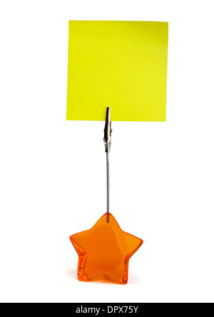 Yellow sticky note in paper holder isolated on white Stock Photo