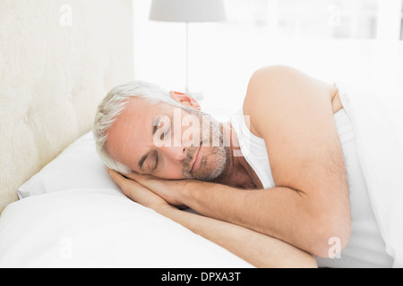 Mature man sleeping in bed Stock Photo