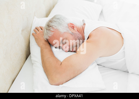 Mature man sleeping in bed Stock Photo