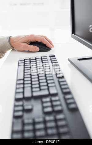 Closeup of a businessmans hand using computer mouse Stock Photo