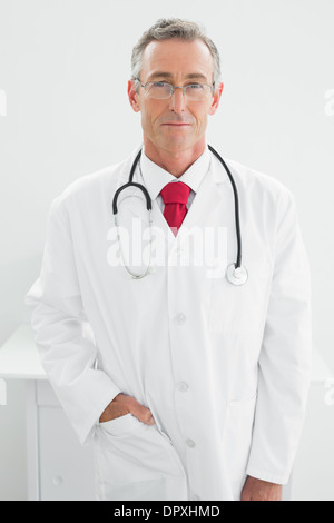 Confident male doctor standing in medical office Stock Photo