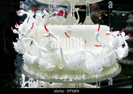 close up on wedding cake with lot of swan figures Stock Photo