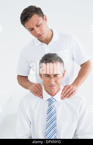 Male chiropractor massaging patients neck Stock Photo