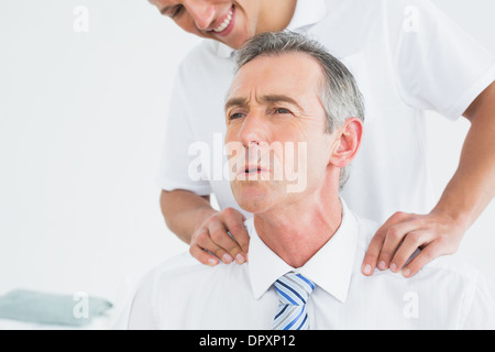 Chiropractor massaging patients neck Stock Photo