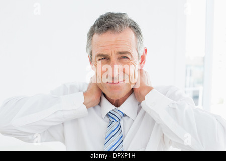 Portrait of a mature man suffering from neck pain Stock Photo