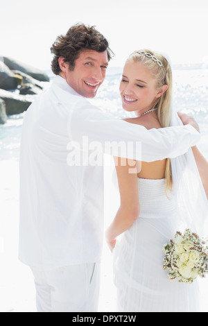 Smiling bride and groom looking at camera Stock Photo
