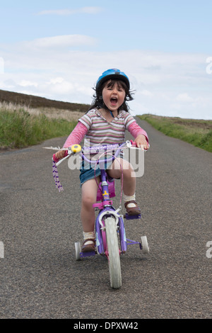 Young girl happy on a bike Stock Photo