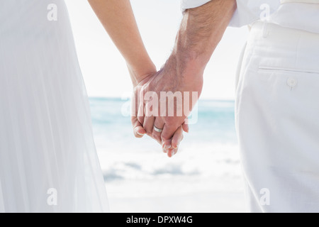 Bride and groom holding hands close up Stock Photo