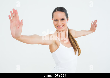 Smiling fit young woman doing pilate exercises Stock Photo