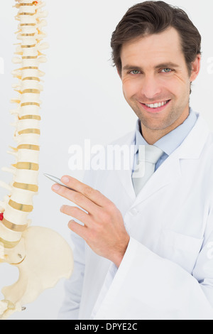 Portrait of a smiling doctor with skeleton model Stock Photo